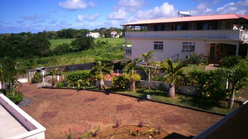 a house with a large yard in front of it at Villa Victoria in Trou dʼ Eau Douce