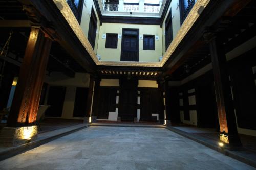 an inside view of a building with columns and a ceiling at Deewanji Ni Haveli in Ahmedabad