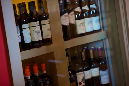 a bunch of bottles of wine on a shelf at Mercure Thame Lambert Hotel in Chinnor
