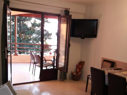 a living room with a sliding glass door with a balcony at Apartment Feral in Neum