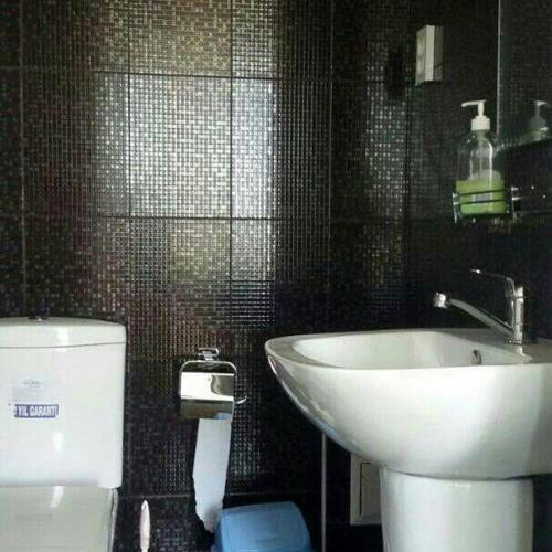 a bathroom with a toilet and a sink at Bely Parus in Bosteri