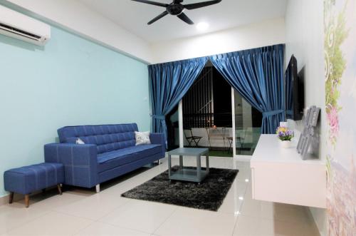 a blue living room with a blue couch and a table at H2H - Nichole Maison - Majestic Ipoh in Ipoh
