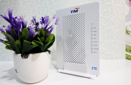 a wii remote sitting next to a vase of purple flowers at H2H - Nichole Maison - Majestic Ipoh in Ipoh