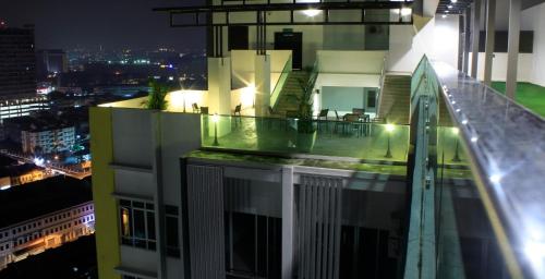 a balcony of a building at night at H2H - Nichole Maison - Majestic Ipoh in Ipoh