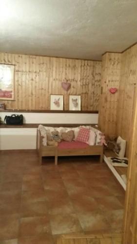 a room with a bed with a teddy bear on it at BARDONECCHIA SCI E RELAX in Bardonecchia