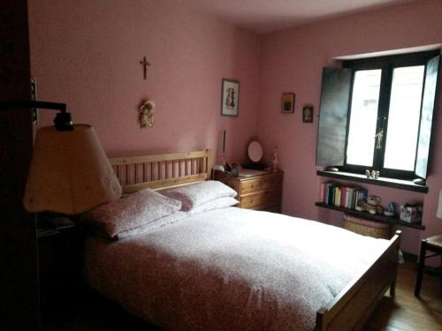 a bedroom with a bed and a cross on the wall at BARDONECCHIA SCI E RELAX in Bardonecchia