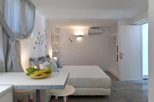 a bedroom with a bed and a bowl of fruit on a table at Efi Studios in Drios