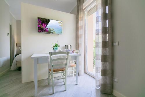 a white table and chair in a room with a window at San Lorenzo Apartments in Sirmione