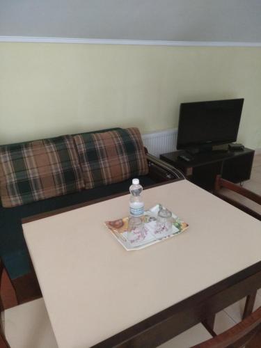a table with a bottle of water on top of it at Inter Hotel in Ternopilʼ