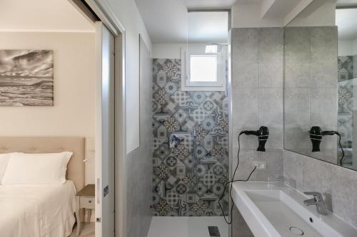 a bathroom with a shower and a sink and a bed at San Lorenzo Apartments in Sirmione