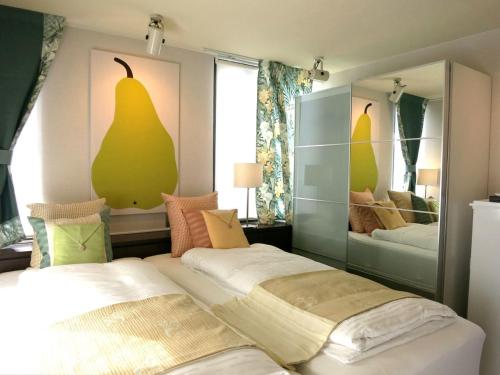 a bedroom with two beds and a large mirror at AH87 Osaka in Suita