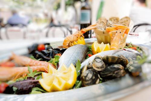 a tray of vegetables and seafood on a table at San Lorenzo Apartments in Sirmione