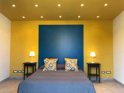 a bedroom with a bed with two lamps on either side at Terra di Sicilia in Avola