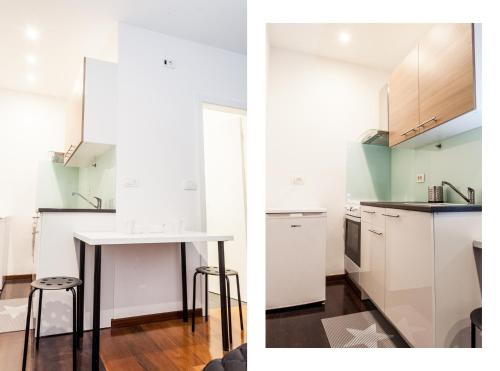a kitchen with white cabinets and a table and stool at Naja's apartments (apartment 1) in Koper