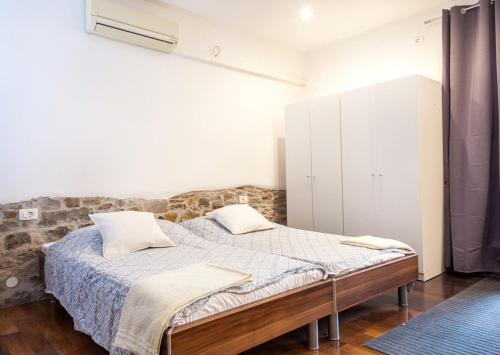 a bedroom with a bed with two pillows on it at Naja's apartments (apartment 1) in Koper