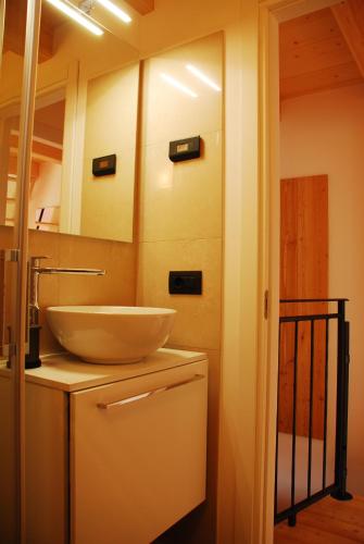 a bathroom with a bowl sink on a counter at La casa del borgo in Dervio