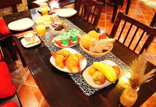 a table with plates of breakfast foods on it at Max Piran in Piran