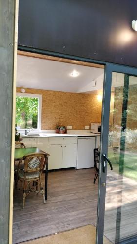 a kitchen and dining room with a table and a counter at Domaine de Keravel in Plouha