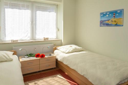เตียงในห้องที่ Ferienwohnung Relax 5011 - Fehmarn