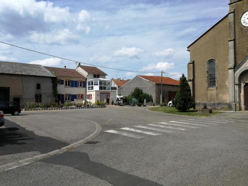 an empty street in a town with a clock tower at Chez Violette in Destry