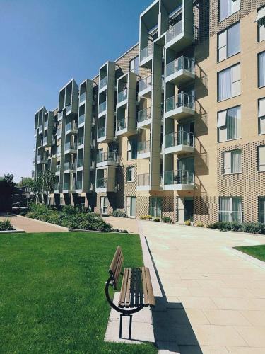 a park bench in front of a large apartment building at Great Northern Road Apartment in Cambridge