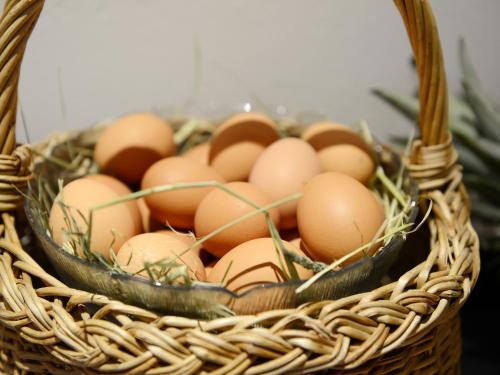 a basket filled with brown eggs on a table at Hotel Purvita by Oberlechner in Maranza