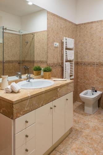a bathroom with a sink and a toilet at Furadouro Surf Camp (House) in Ovar