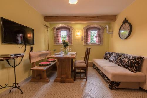 a living room with a couch and a table at Apartments Villa Sušanj in Matulji