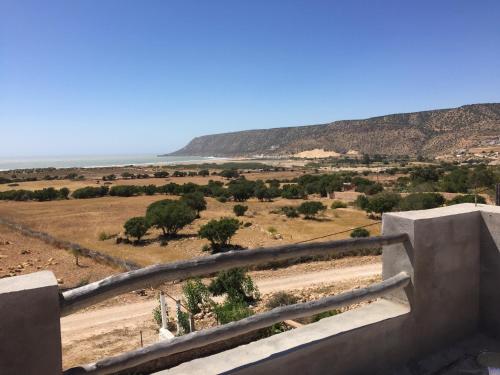 a view of a desert with trees and a mountain at Aziki in Essaouira