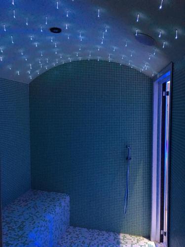 a bedroom with a bed in a room with blue lights at Hotel Villa Camilla in Varazze