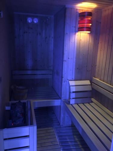 a sauna with two benches and a lamp in a room at Hotel Villa Camilla in Varazze