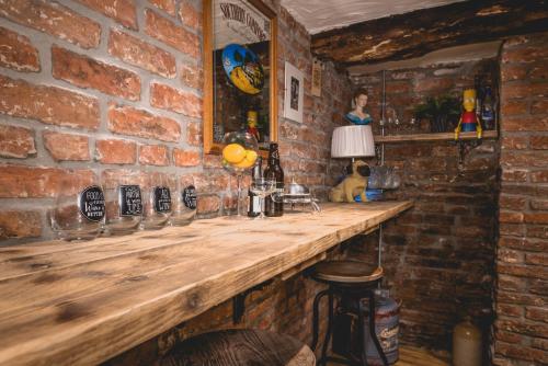 a brick wall with a wooden counter in a bar at 40 Kirkgate in Thirsk