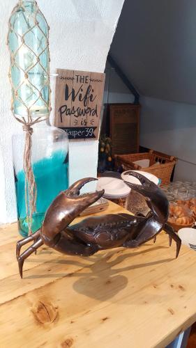 a statue of a brown lobster sitting on a table at The Sunfold in Weston-super-Mare