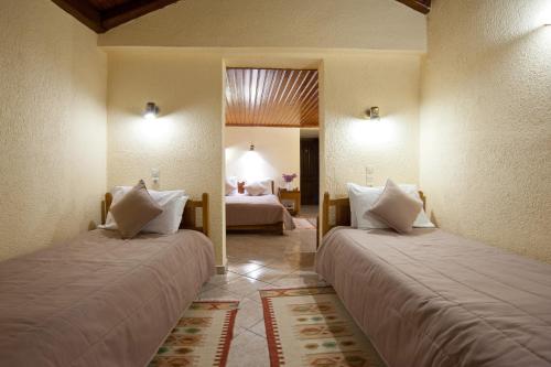 a hotel room with two beds and a bedroom at Hermes Delphi Hotel in Delfoi