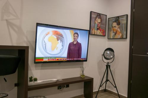 a flat screen tv on a wall with pictures at Zen Luxury Living in Thessaloniki