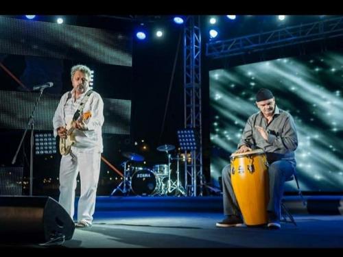 two men standing on a stage with a drum at Apartment Feral in Neum
