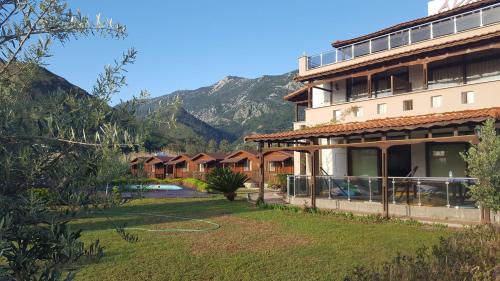 a view of a resort with a mountain in the background at Ada Adrasan Hotel in Adrasan