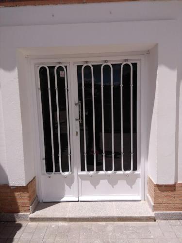 a white door with iron bars on it at Las Eras 2 in Herencia