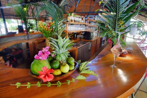 a bowl of fruit on a table in a bar at L'heure Bleue in Ambatoloaka