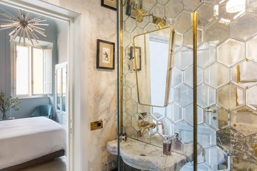 a bathroom with a glass shower with a sink at Casa Iris Bed and Breakfast in Orbetello