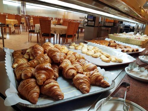 a display of croissants and other pastries on a table at KAKTUS Hotel Kaktus Albir in Albir