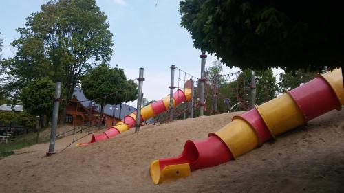 a playground with a row of colorful slides at Eva in Mrągowo