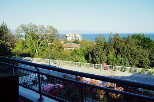a balcony with a view of a road and trees at Apartman Andrijana Lovran in Lovran