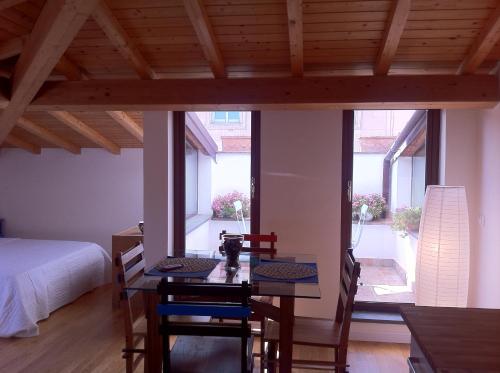 a dog sitting on a table in a bedroom at BBCasablu in Acireale