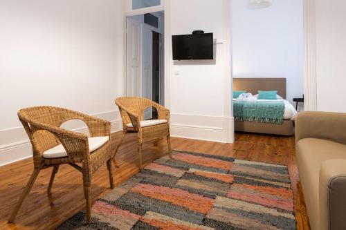 a living room with two chairs and a couch at Furadouro Surf Camp (House) in Ovar