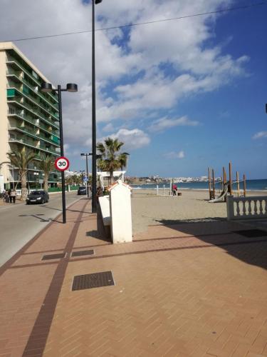 a street light on a sidewalk next to the beach at Holiday wanda in Fuengirola