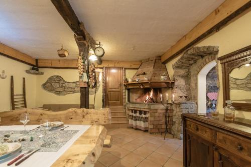 a kitchen with a stone fireplace in a room at Apartments Villa Sušanj in Matulji