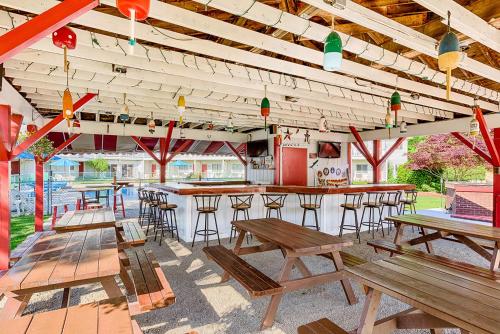 a bar with wooden tables and chairs in a restaurant at Rhumb Line Resort in Kennebunkport