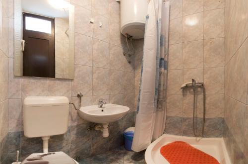 a bathroom with a toilet and a sink and a shower at Room Dioklecijan in Split