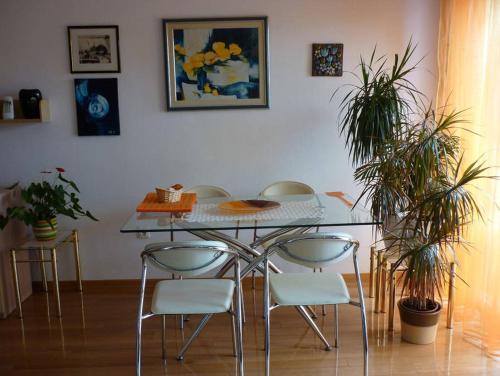 a dining room table and chairs with plants in a room at APARTMENT IVA 2 in Ližnjan